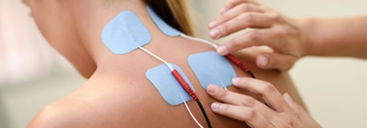 Electroanalgesia Therapy pads on a persons back.